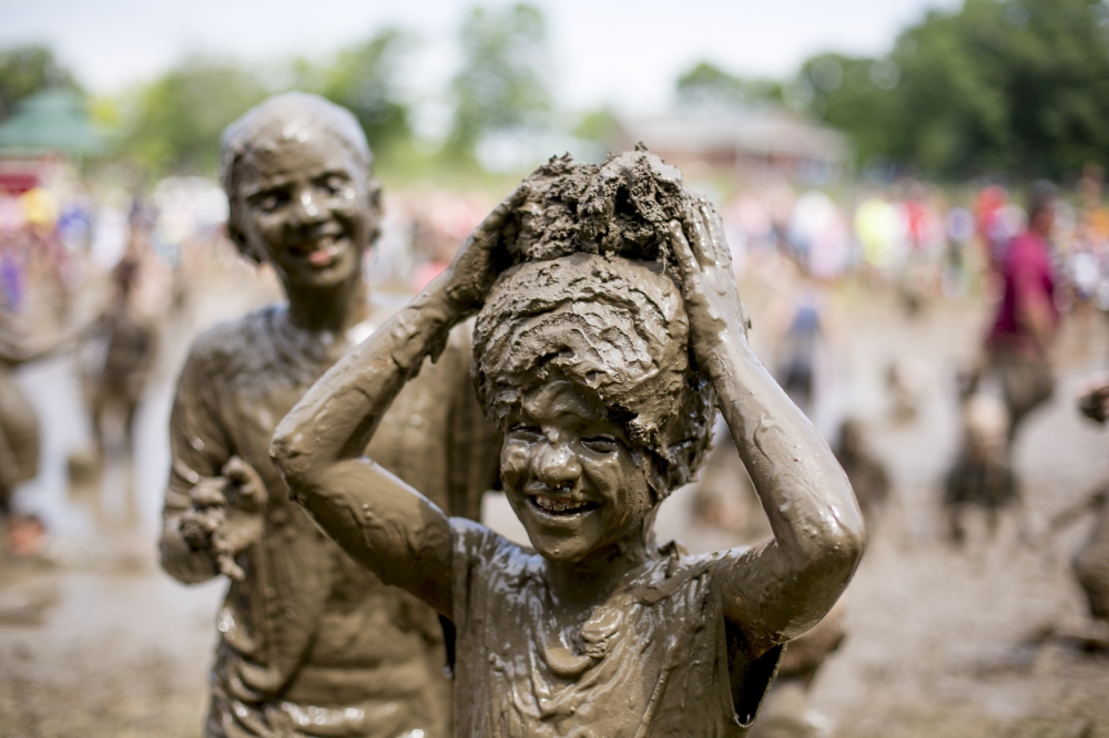 Children play in the mud during the 31st annual Wayne County Mud Day at Nankin Mills Park on Wednesday in Westland, Michigan. - AFP