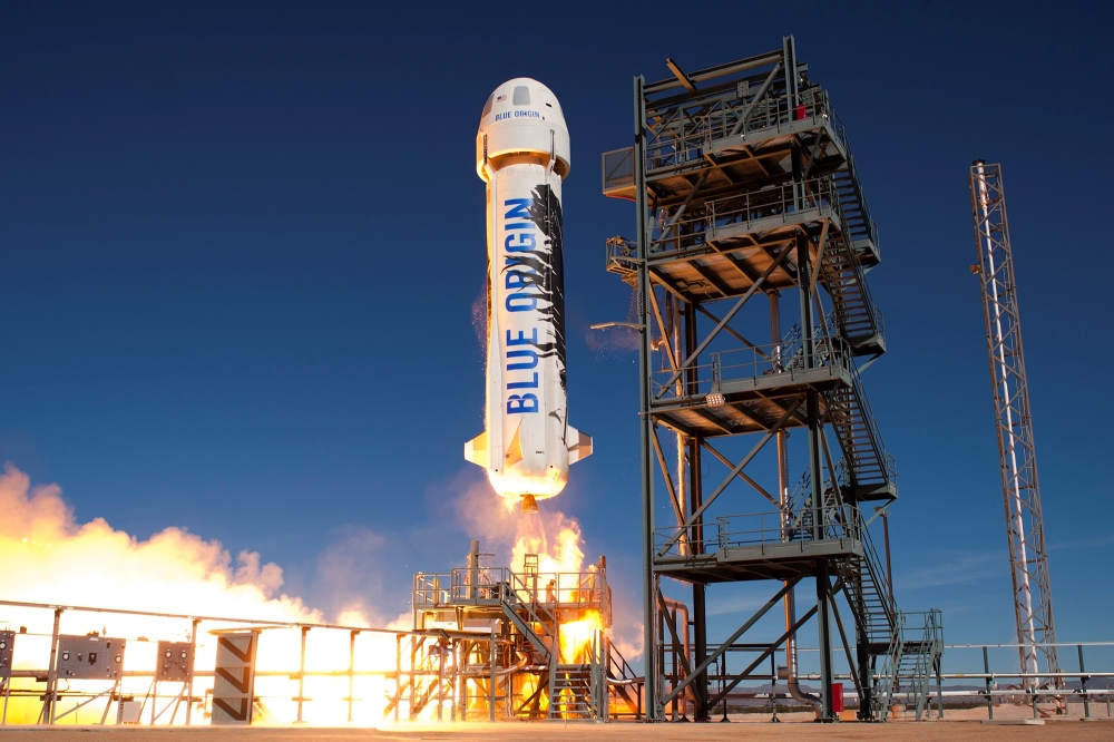 This handout photograph obtained courtesy of Blue Origin in an undisclosed date and place shows the New Shepard booster. The two companies leading the pack in the pursuit of space tourism say they are just months away from their first out-of-this-world passenger flights -- though neither has set a firm date. Virgin Galactic, founded by British billionaire Richard Branson, and Blue Origin, by Amazon creator Jeff Bezos, are racing to be the first to finish their tests -- with both companies using radically different technology. — AFP