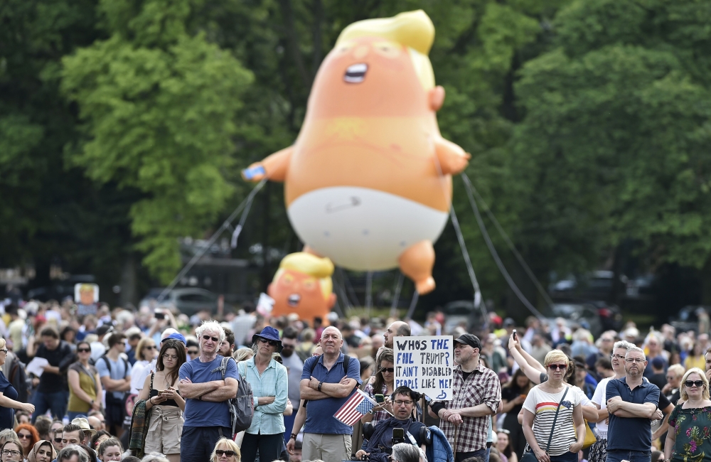 A giant balloon depicting US President Donald Trump as an orange baby is launched as protesters gather in the Meadows, after taking part in the Scotland United Against Trump march through the streets of Edinburgh, Scotland, on Saturday. — AFP