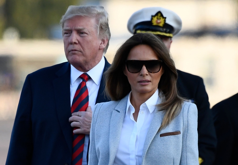 US President Donald Trump, left, and US First Lady Melania Trump walk towards the presidential car upon arrival at Helsinki-Vantaa Airport in Helsinki, on Sunday on the eve of a summit in Helsinki between the US President and his Russian counterpart. — AFP