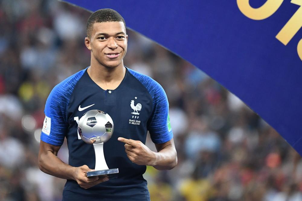 France’s forward Kylian Mbappe poses with the FIFA Young Player award during the trophy ceremony at the end of the Russia 2018 World Cup final at the Luzhniki Stadium in Moscow Sunday. — AFP