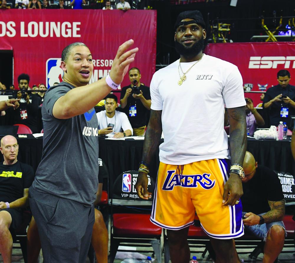 Head coach Tyronn Lue (L) of the Cleveland Cavaliers talks with LeBron James of the Los Angeles Lakers after a quarterfinal game of the 2018 NBA Summer League between the Lakers and the Detroit Pistons at the Thomas & Mack Center in Las Vegas Sunday. — AFP 