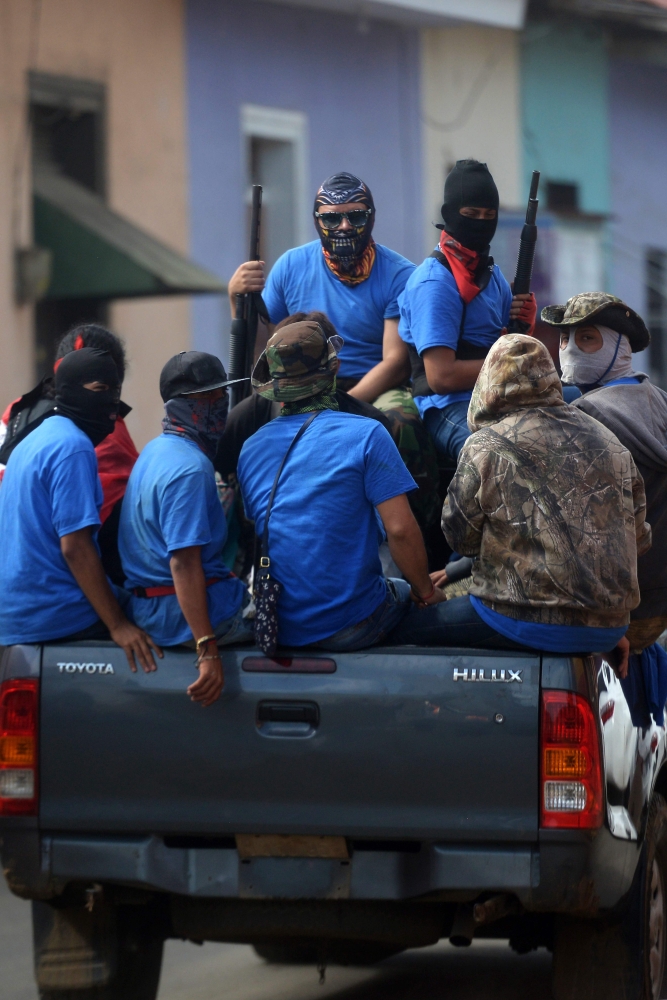 Paramilitaries are seen on trucks at Monimbo neighborhood in Masaya, Nicaragua, on Wednesday, following clashes with anti-government demonstrators. — AFP