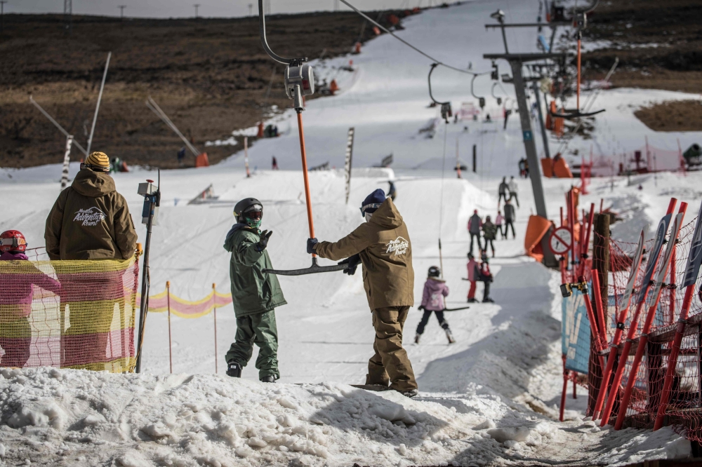 Young skiers get ready for the slope at Afriski in the Maluti Mountains of the Southern African Kingdom of Lesotho.  Nestled high in the mountains of Lesotho, skiers and snowboarders from around the world rub shoulders at Africa's leading ski resort which is cultivating a loyal clientele despite its diminutive size and remote location. — AFP