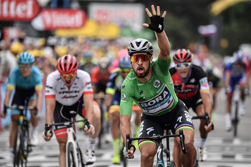 Slovakia's Peter Sagan, wearing the best sprinter's green jersey, celebrates as he crosses the finish line to win the 13th stage of the 105th edition of the Tour de France cycling race, between Le Bourg-d'Oisans and Valence, on Friday. — AFP