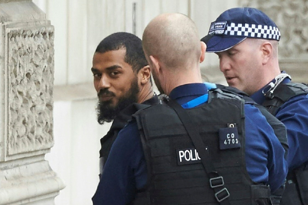 Firearms officers from the British police detain a man near the Houses of Parliament in central London in this April 27, 2017 file photo. — AFP