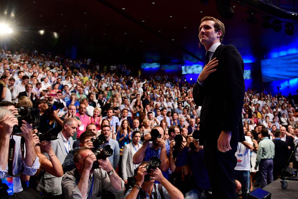 Lawmaker Pablo Casado acknowledges delegates after being chosen as the next leader of Spain's Popular Party (PP) at the end of a party meeting in Madrid, Saturday. Casado has promised 