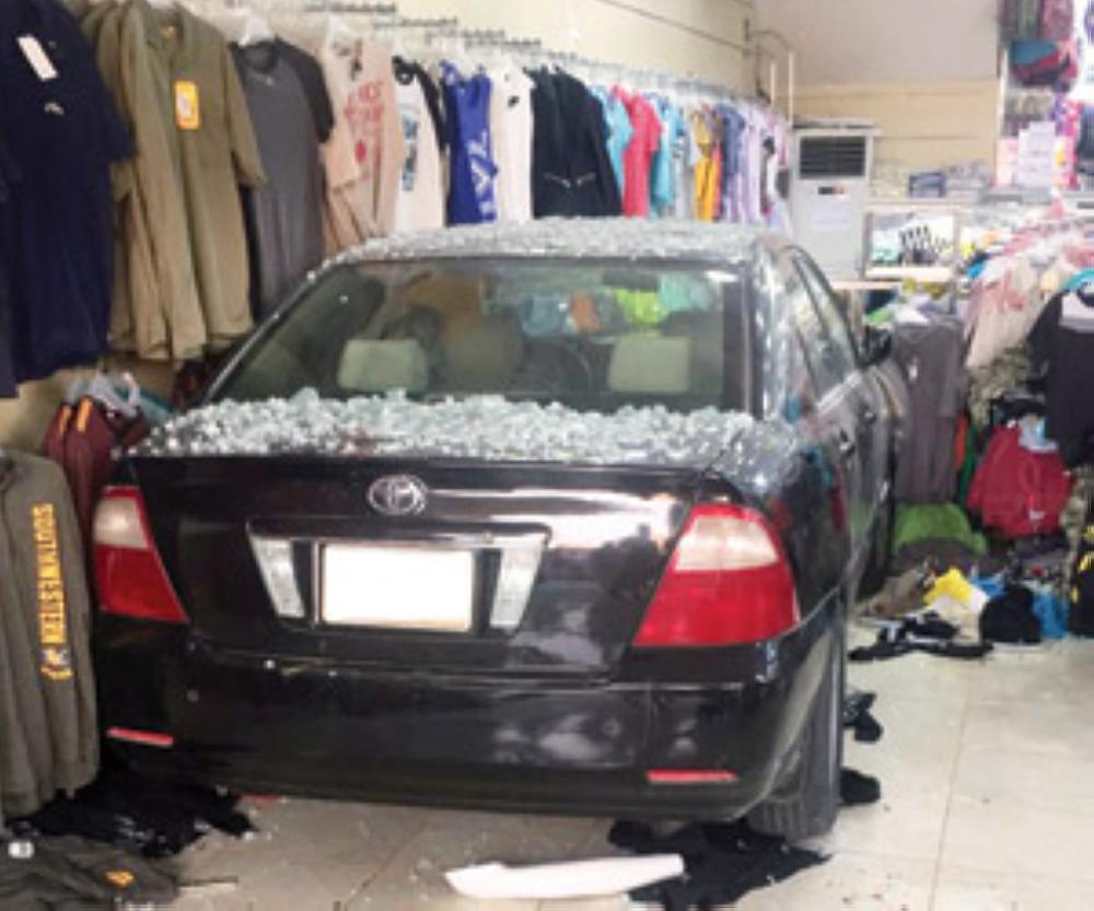 The car with the shards of glass inside a shop in Al-Mubraz town. — Courtesy photo by Al-Watan