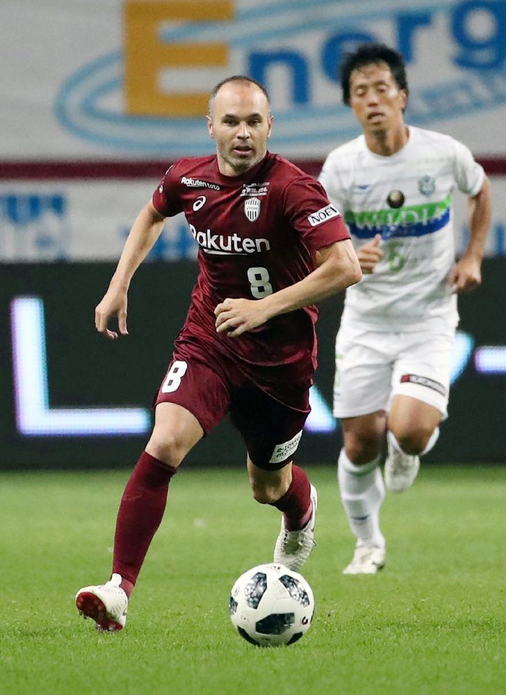 J-League club team Vissel Kobe’s new signing, Spanish player Andres Iniesta (L), controls the ball during their match against Shonan Bellmare at Noevir Stadium in Kobe, Japan, Sunday. —AFP 