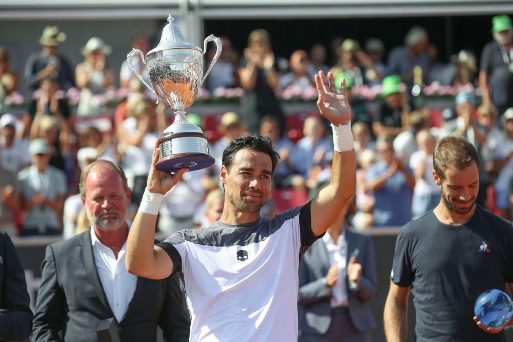 Fabio Fognini of Italy celebrates with the trophy after beating Richard Gasquet of France in the final of the Swedish Open Tennis Tournament in Bastad, Sweden, Sunday. — AFP