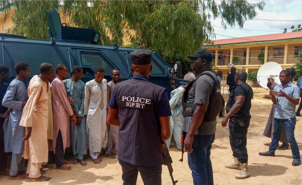 Suspected Boko Haram militants parade in front of the police officers, in Maiduguri, northeast Nigeria, in this July 18, 2018 file photo. — AFP
