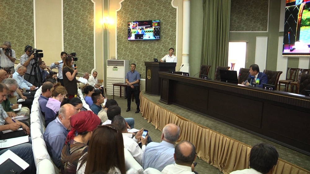 This image grab taken from an AFPTV video shows Tajik Minister of the Interior Ramazon Hamro Rahimzoda, right, addressing a press conference in Dushanbe on Monday, after four tourists, including two Americans, were killed in Tajikistan by armed attackers on July 29. — AFP