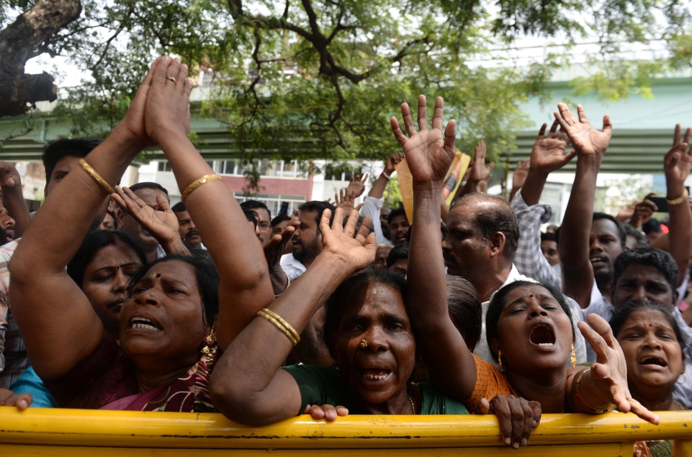 Dravida Munnetra Kazhagam (DMK) party supporters pray as they gather in front hospital where party president M. Karunanidhi is being treated in Chennai on Monday. — AFP
