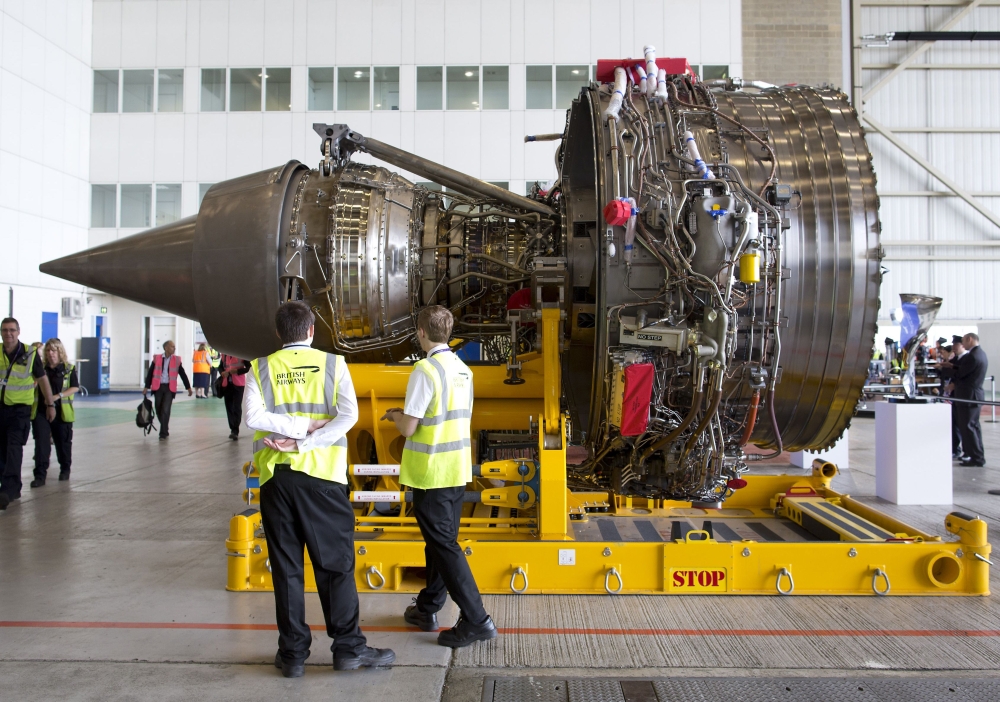 In this file photo, staff look at a Rolls-Royce Trent 1000 turbo fan engine during an event to mark the arrival of a British Airways Airbus A380 at Heathrow Airport in London.  Britain's Rolls-Royce sank into the red in the first half after taking another big hit from expensive repairs to its Trent 1000 engine, it said on Thursday. — AFP