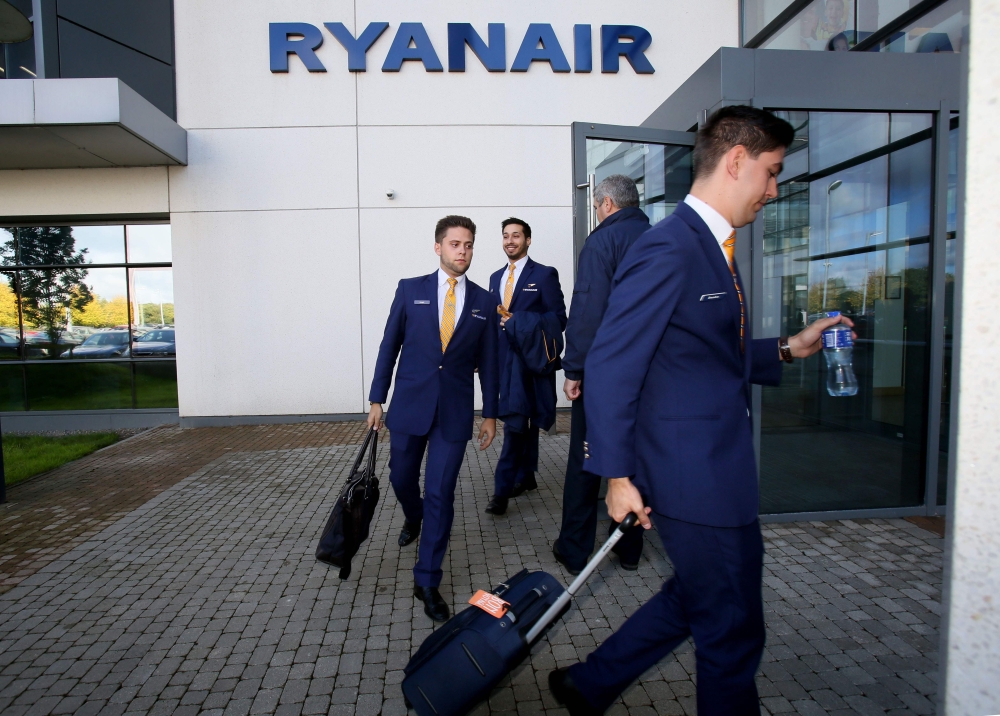 In this file photo staff leave Ryanair headquarters at Airside Business Park in Dublin. Ryanair on Frdiay proposed third-party mediation as its Irish pilots went on strike for a fourth day, disrupting flights at Europe's biggest no-frills airline. — AFP