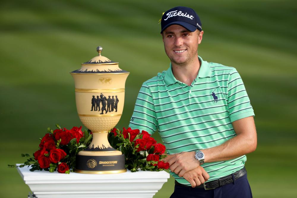 Justin Thomas poses with the Gary Player Cup after winning the World Golf Championships-Bridgestone Invitational at Firestone Country Club South Course in Akron, Ohio, Sunday. — AFP
