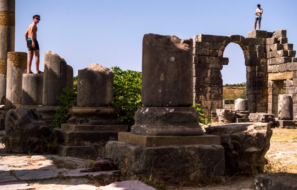 A tourist walks through the ruins of the ancient Roman site of Volubilis, near the town of Moulay Idriss Zerhounon in Morocco's north central Meknes region. Situated in the center of a fertile plain at the foot of Mount Zerhoun, the towering remains of Morocco's oldest Roman site, Volubilis, were long neglected. But after decades of looting and decay, custodians of the now closely guarded ancient city are turning the page and attracting back tourists. — AFP