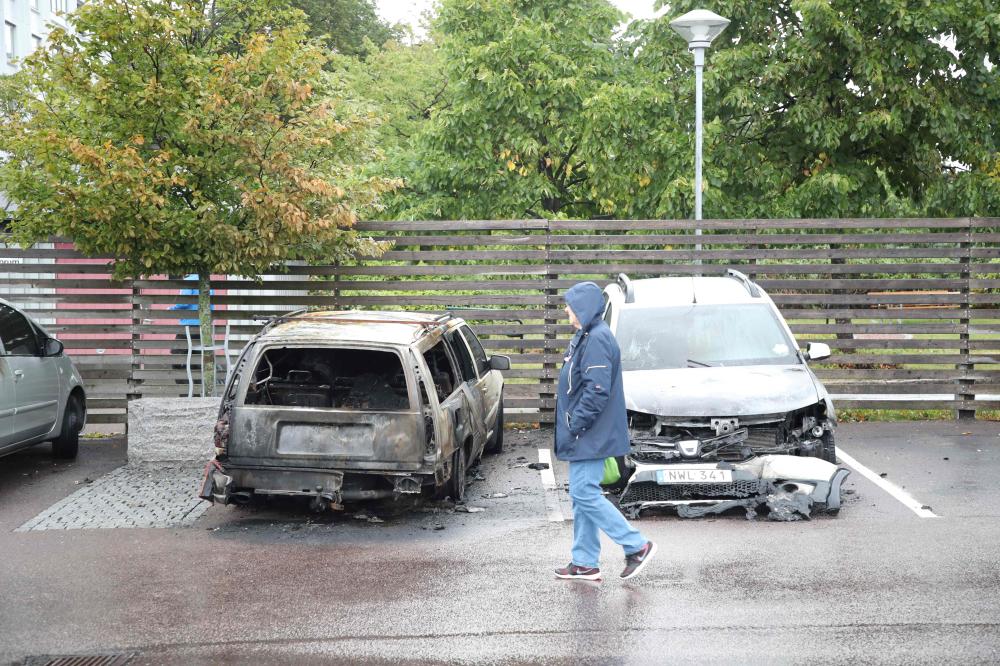 Burned cars are pictured at Froelunda Square in Gothenburg, Sweden, on Tuesday. — AFP
