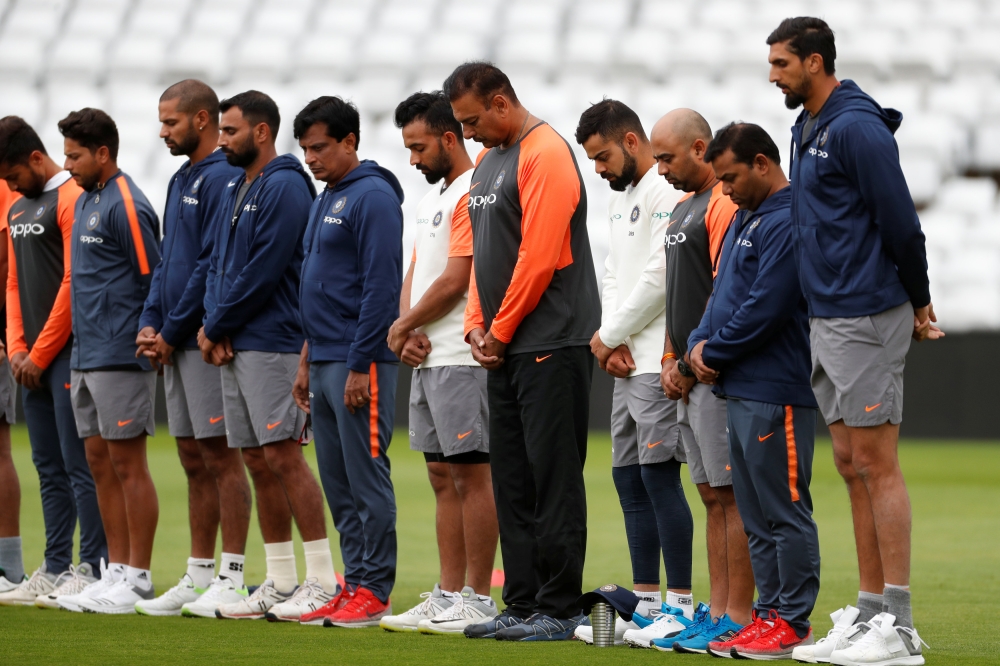 India's Virat Kohli, head coach Ravi Shastri and teammates during a minutes silence in memory of former India player Ajit Wadekar during nets at Trent Bridge. — Reuters