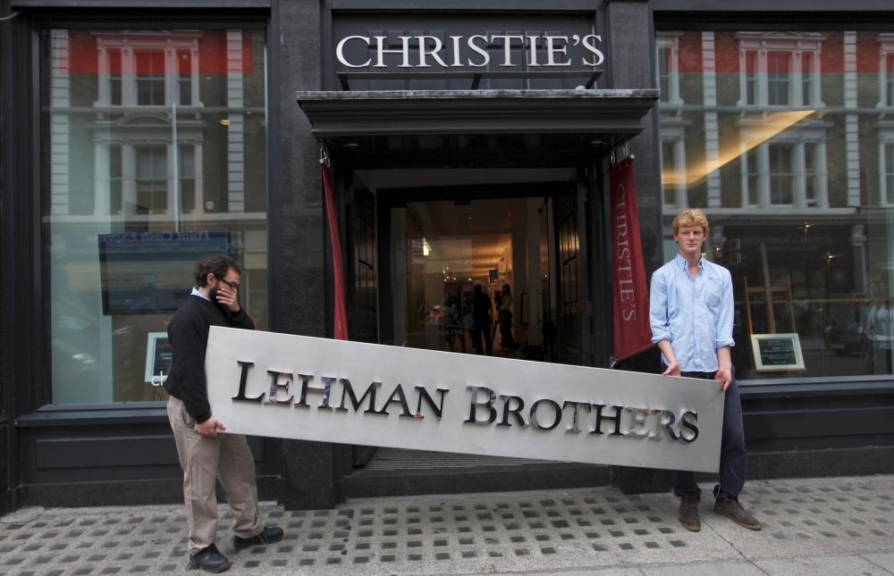File photo shows a Christie's employees posing with a Lehman Brothers sign at Christie's in central London. — Reuters
