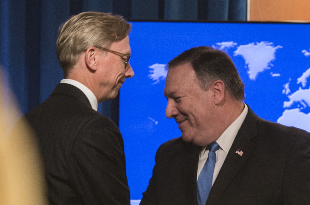 The State Department’s director of policy planning and head of the Iran Action Group, Brian Hook, left, shakes hands with US Secretary of State Mike Pompeo after the announcement of the Iran Action Group during a press briefing at the State department in Washington on Thursday. — AFP