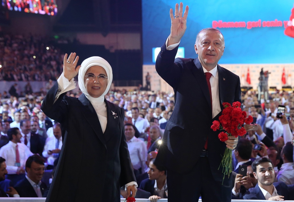 Turkish President Recep Tayyip Erdogan, right, and his wife Emine Erdogan, left, greet supporters of the ruling Justice and Development Party (AKP) during the sixth Congress of the ruling AK Party (AKP) in Ankara on Saturday. — AFP