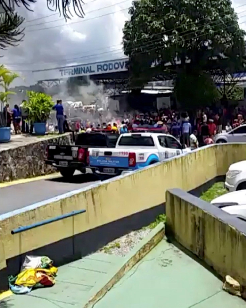 People look at a demonstration at the interstate bus terminal in Pacaraima, Brazil, on Saturday in this still image obtained from a social media video. — Reuters