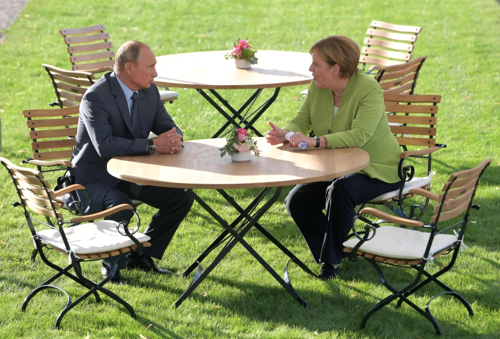 German Chancellor Angela Merkel, right, meets with Russian President Vladimir Putin at Schloss Meseberg castle in Meseberg, northeastern Germany, on Saturday. — AFP