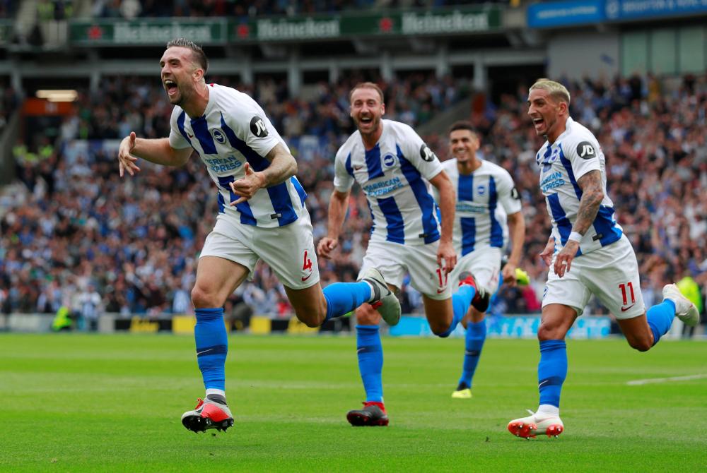 Brighton's Shane Duffy celebrates with teammates after scoring their second goal against Manchester United during their English Premier League match at American Express Community Stadium in Brighton Sunday. — Reuters