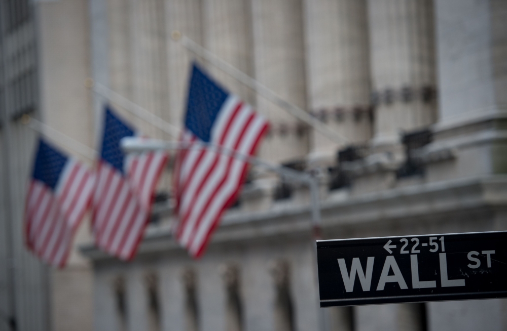 In this file photo, a street sign is seen near the New York Stock Exchange in New York. Bolstered by a period of extraordinary monetary stimulus followed by generous tax cuts, Wall Street stands at the cusp of another landmark this week. — AFP