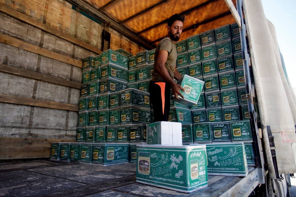 An Iraqi worker unloads a truck from Iran, loaded with cosmetics, in Baghdad, in this Aug. 17, 2018 file photo. — Reuters