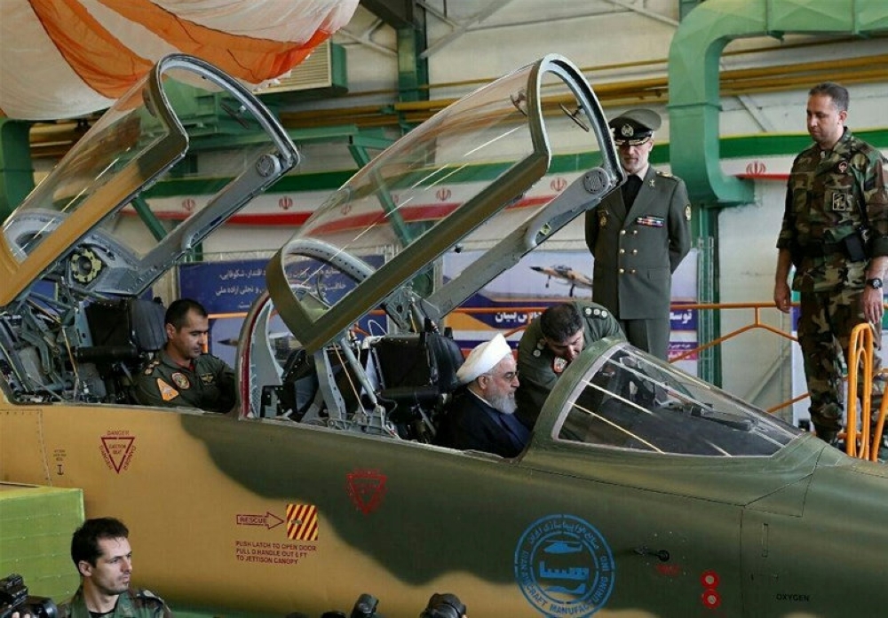 Iranian President Hassan Rouhani is seen in a newly unveiled fighter jet in Tehran on Tuesday. — AFP