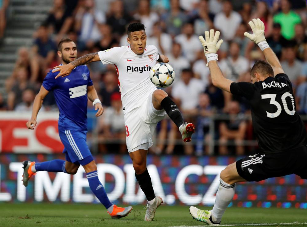 Sevilla's Guilherme Arana in action against Sigma Olomouc's goalkeeper Milos Buchta during their Europa League playoff first leg at Andruv Stadion, Olomouc, Czech Republic, Thursday. — Reuters