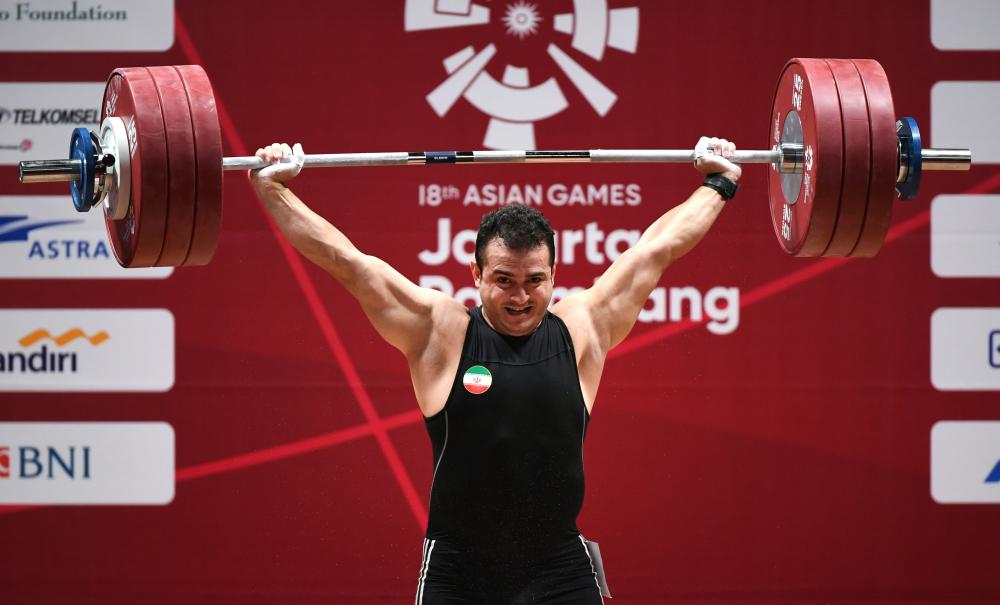 Sohrab Moradi of Iran shatters the world record in the men's 94kg class weightlifting event at the 2018 Asian Games in Jakarta Shatters. — AFP