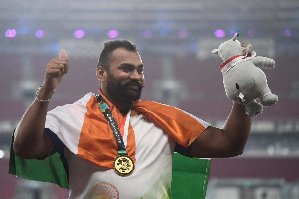 Sohrab Moradi of Iran shatters the world record in the men's 94kg class weightlifting event at the 2018 Asian Games in Jakarta Shatters. — AFP