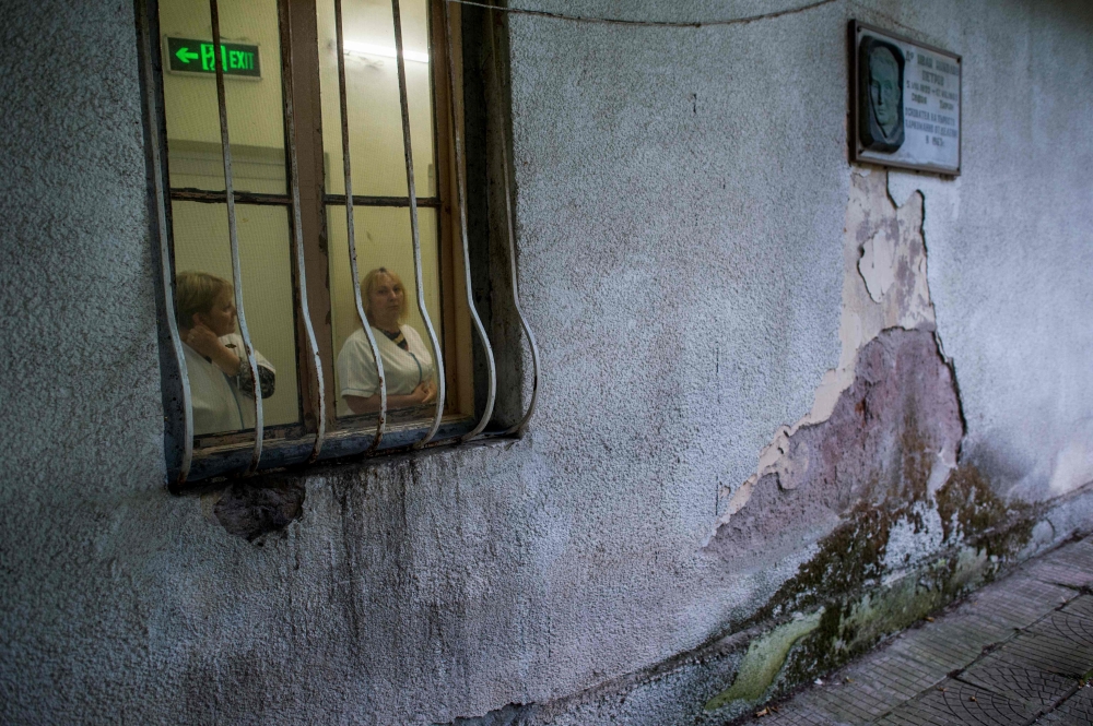 Medical workers look on during an inspection of the European Psychiatric Association (EPA) in the psychiatric hospital in Kurilo, near Sofia. - AFP