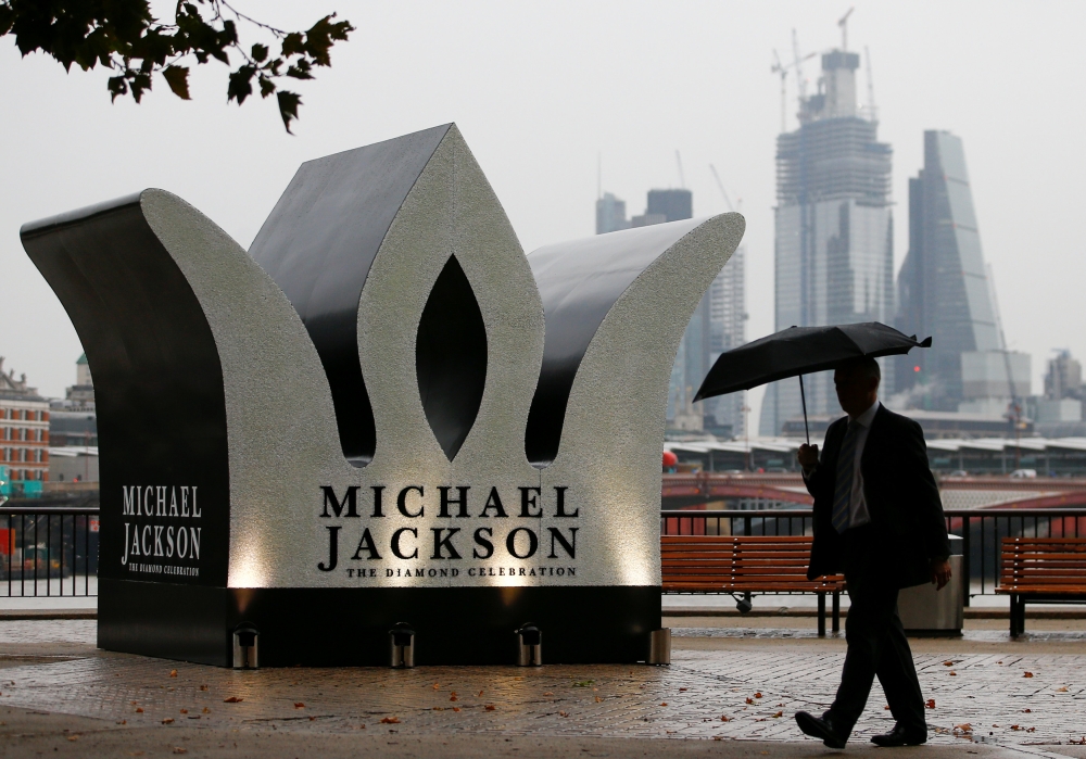 A man walks past a Giant Crown installed to celebrate the 60th birthday of Michael Jackson, on the South Bank in London, on Wednesday. — Reuters