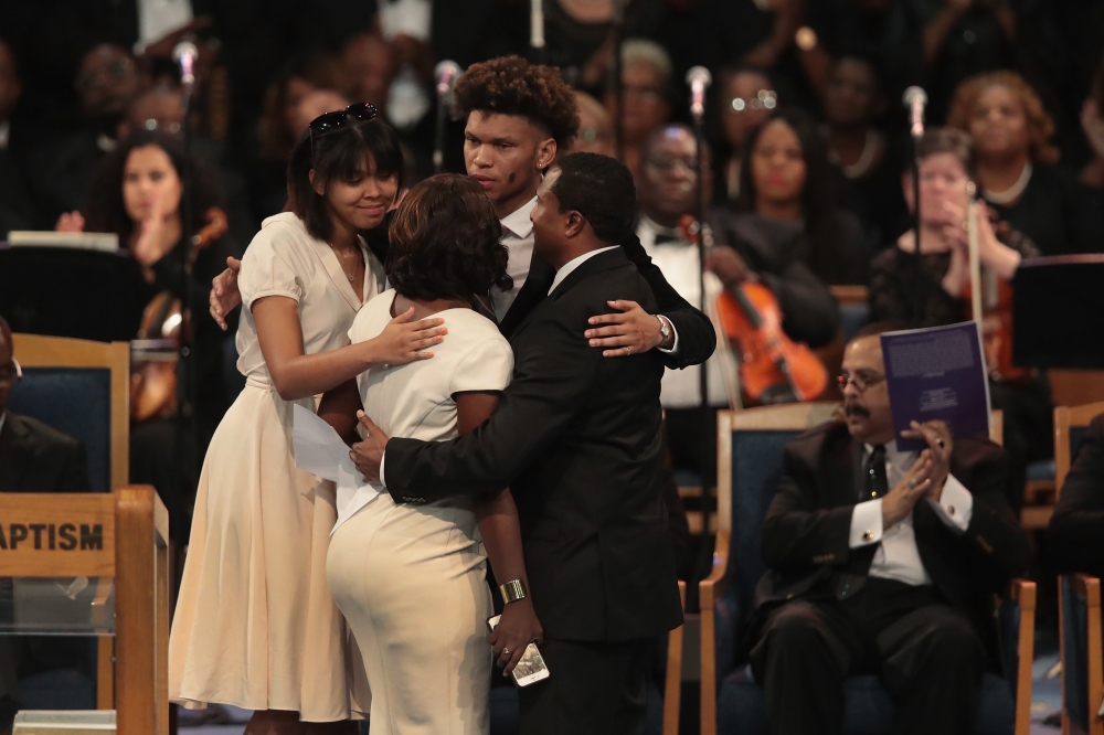 Family members of Aretha Franklin embrace after sharing stories of the late singers life at her funeral service at the Greater Grace Temple in Detroit, Michigan, on Friday. — AFP