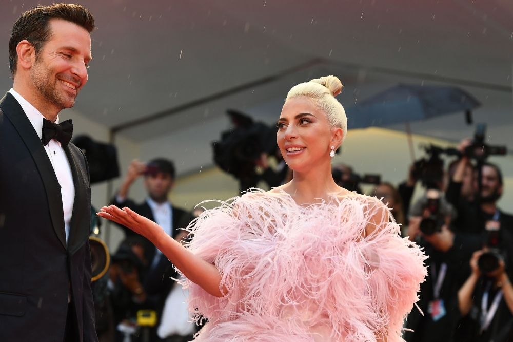 Singer and actress Lady Gaga and director and actor Bradley Cooper arrive for the premiere of their film 