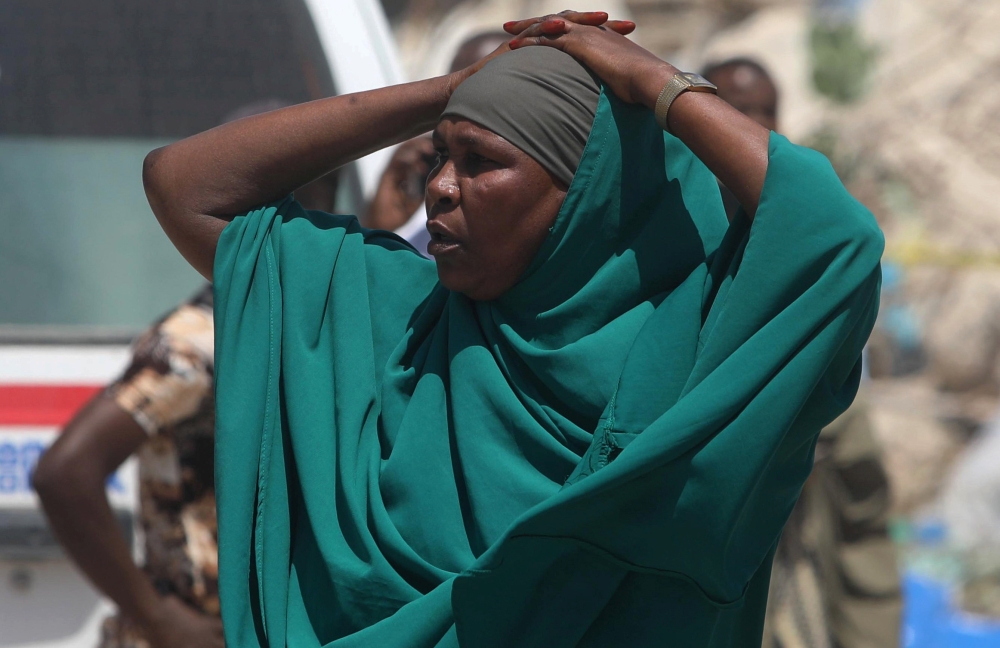 A woman reacts near the scene of a blast in the district office of Hawlwadag in Mogadishu, Somalia, on Sunday. — Reuters