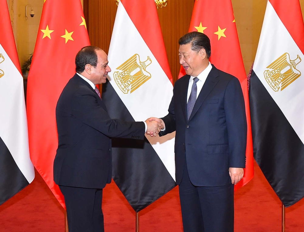 A handout picture released by the Egyptian Presidency on Saturday shows Egyptian President Abdel Fattah El-Sisi (L) shaking hands with China's President Xi Jinping upon the former's arrival in the Chinese capital Beijing. — AFP