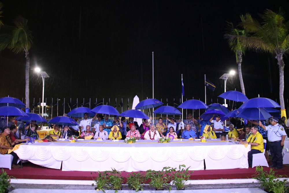 Leaders shield themselves from the rain with umbrellas during the opening ceremony of the Pacific Islands Forum in Yaren. Nauru, on Monday. — AFP