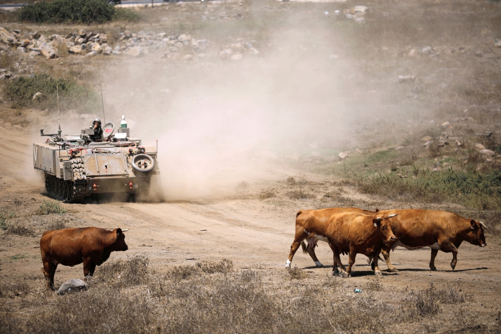 An Israeli soldier rides an armored vehicle during an army drill after the visit of Israeli Defense Minister Avigdor Lieberman in the Israeli-occupied Golan Heights in this Aug, 7, 2018 file photo. — Reuters