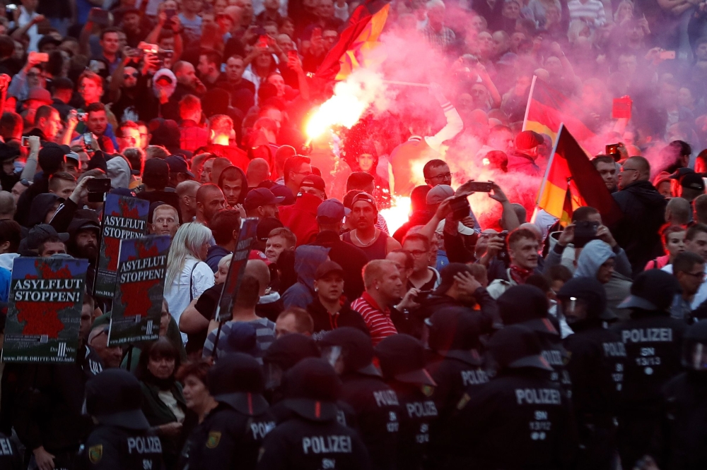 Right-wing demonstrators light flares in Chemnitz, eastern Germany, following the death of a 35-year-old German national who died in hospital in this Aug. 27, 2018 file photo. — AFP