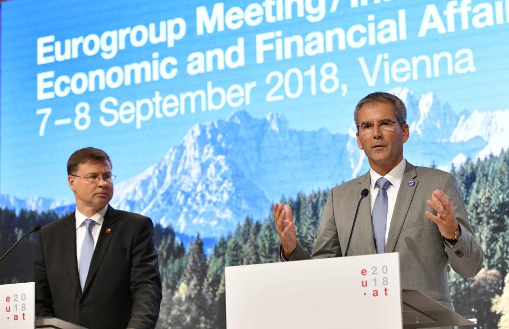 artwig Loeger (R), Austria's Federal Minister of Finance, and Valdis Dombrovskis, European Commissioner for the Euro and Social Dialogue, Financial Stability, Financial Services and Capital Markets, give a news conference following an Eurogroup meeting, Informal meeting of economic and financial affairs ministers in Vienna, Austria, on September 8, 2018. — AFP  