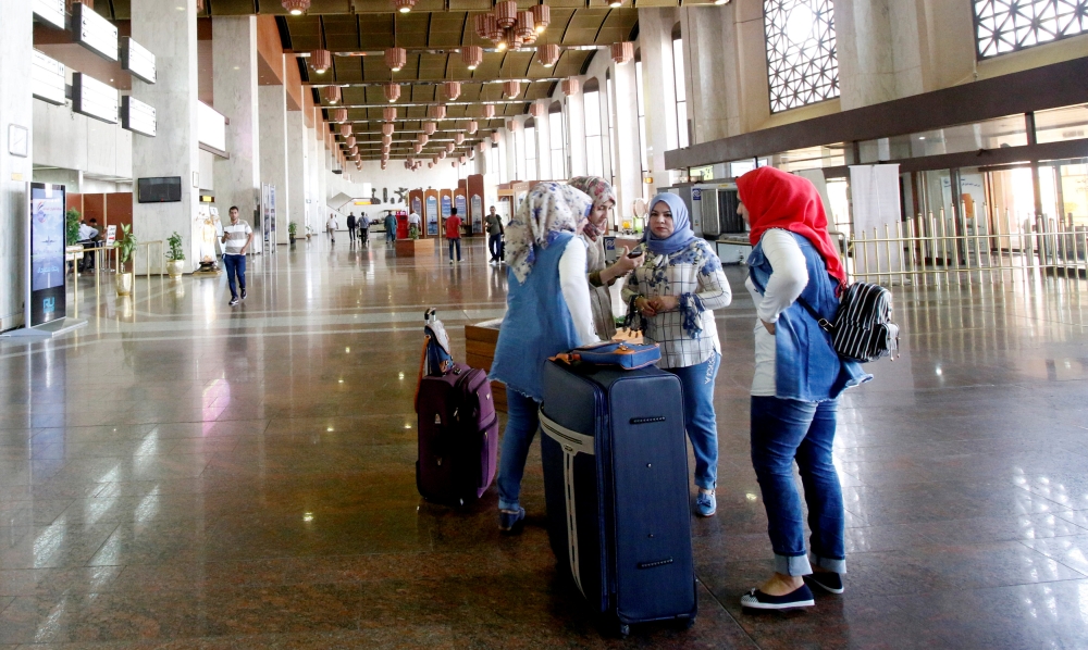 Passengers are seen at Basra airport after it was targeted by rocket fire on Saturday. — Reuters