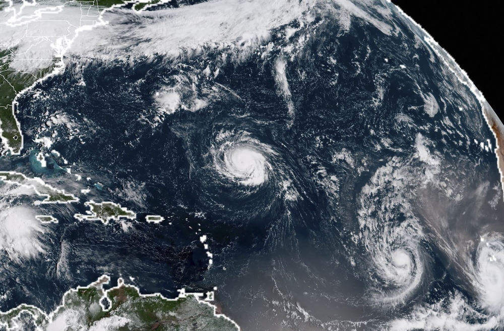 This NOAA/RAMMB satellite image taken at 13:30 UTC on Sunday, shows (L-R) Tropical Storm Florence, Tropical Storm Isaac and Tropical Storm Helene in the Atantic Ocean. Florence is likely to surge back to hurricane strength and take aim for the US East Coast states of North or South Carolina, forecasters warned. — AFP