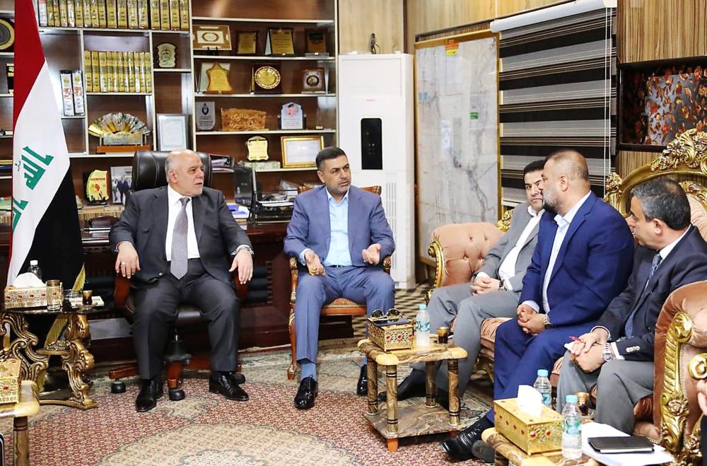 A handout picture released by the Iraqi Prime Minister’s office on Monday shows Iraqi Prime Minister Haider Al-Abadi (L) meeting with local officials in the southern-Iraqi city of Basra, where protests over government neglect had escalated into deadly violence. After 12 protesters were killed and many of Basra’s institutions torched last week, calm returned to the city as Abadi’s political rivals in Baghdad announced their intention to form Iraq’s next government without him. — AFP