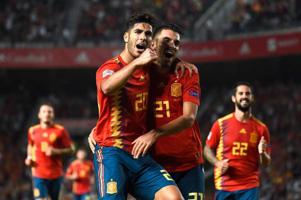 Spain’s midfielder Marco Asensio (L) celebrates with Dani Ceballos after scoring a goal during the UEFA Nations League A group match against Croatia at the Manuel Martinez Valero Stadium in Elche Tuesday. — AFP 