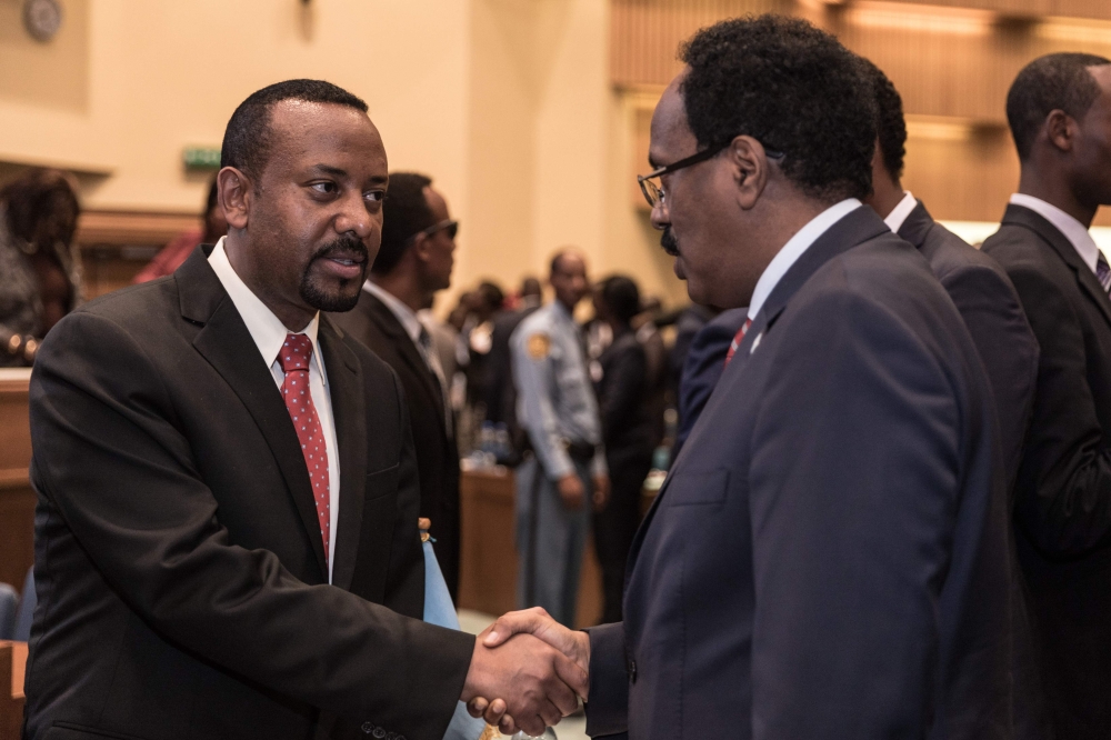 Ethiopia’s Prime Minister Abiy Ahmed, left, speaks with Somalia’s President Mohamed Abdullahi Mohamed at the 33rd Extraordinary Summit of Intergovernmental Authority on Development in Addis Ababa on Sept. 12, 2018. — AFP